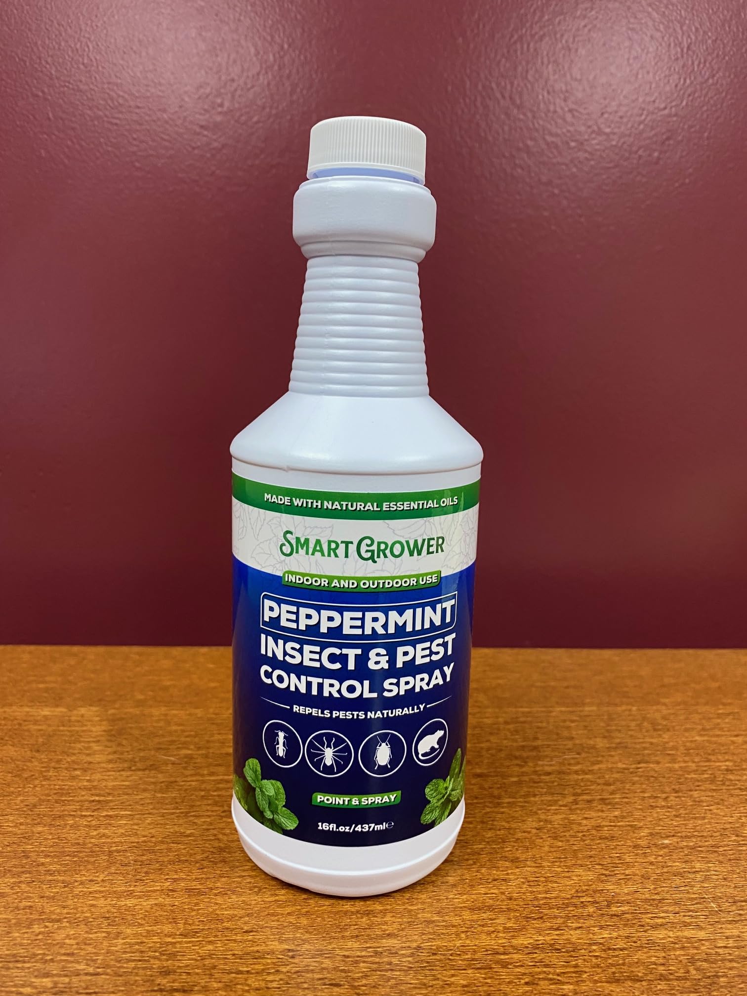 Smart Grower peppermint oil spray being dispensed in the garden.