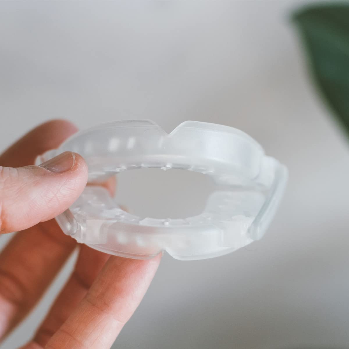 SmartGuard night-use scene in bed highlights practical snore reduction aid