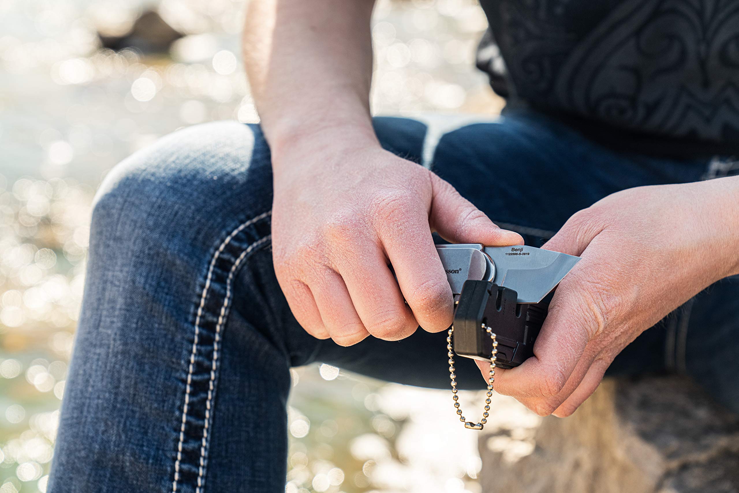 Benji knife carried on belt during outdoor activities like camping.