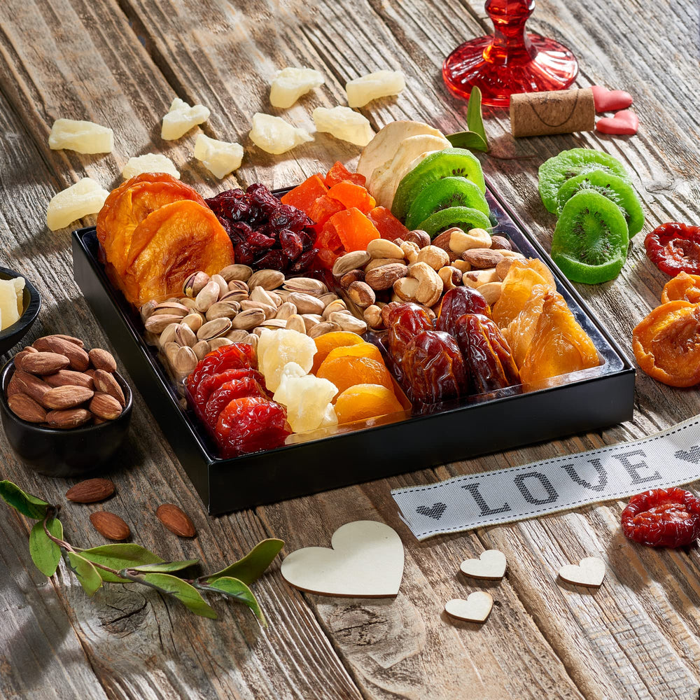Snackberry six-compartment tray displays a variety of dried fruits and nuts for snacking.