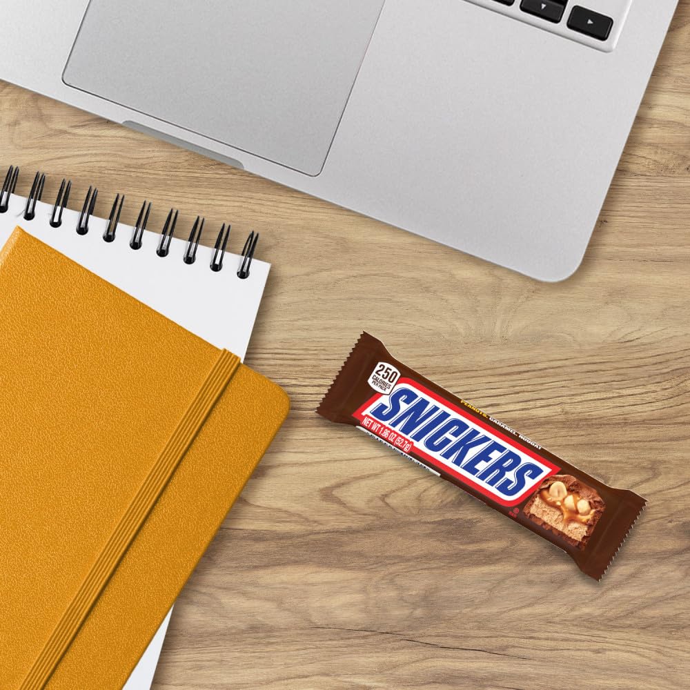 Office pantry dispense with Snickers bulk bars for quick breaks.