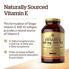 Solgar Vitamin E softgels pouring from a bottle, easy to swallow.