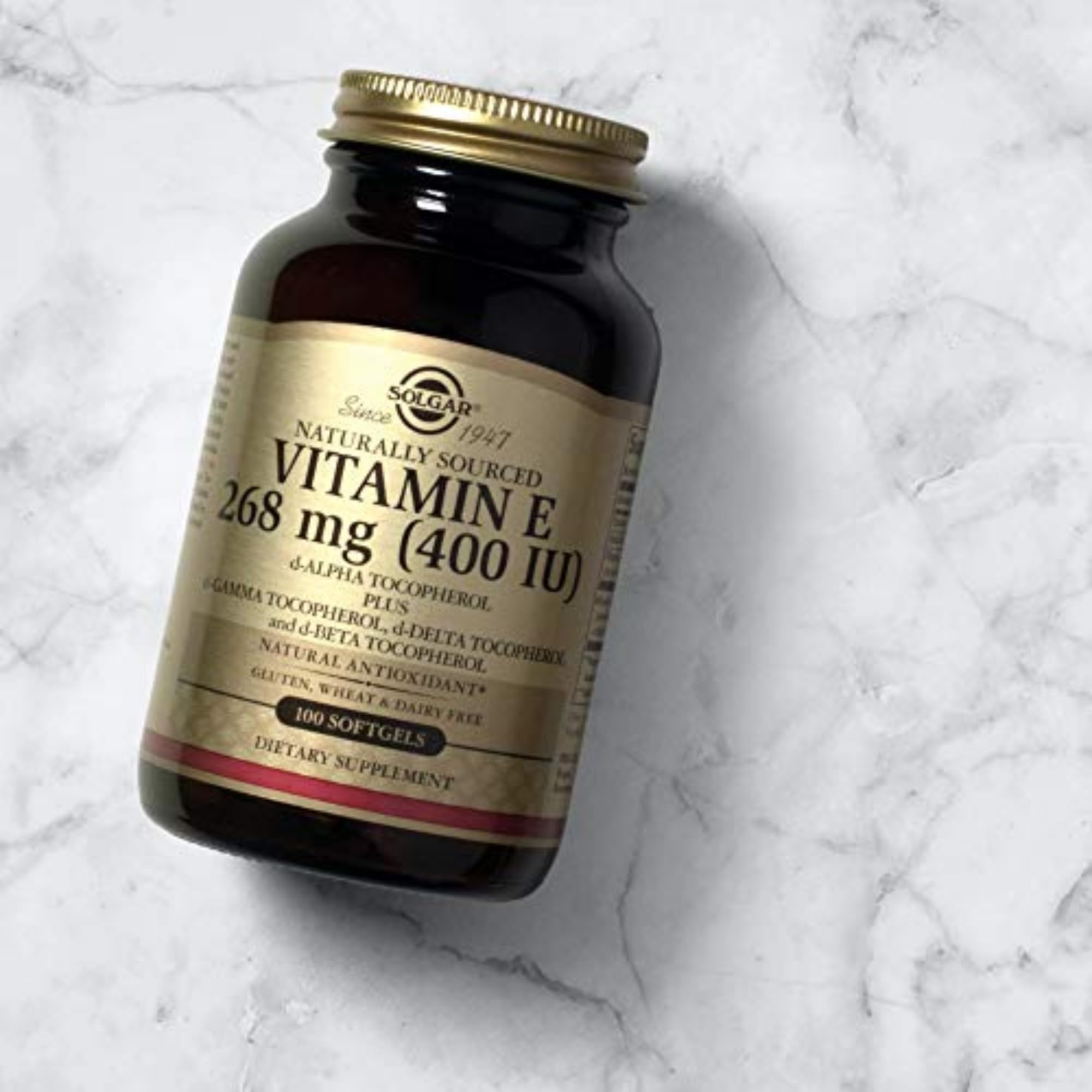 Solgar Vitamin E packaging on kitchen counter; premium skin and immune care potential.