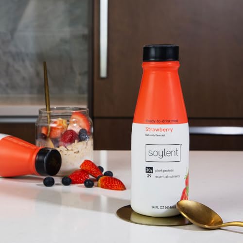 Soylent strawberry bottle on a desk supporting a busy lifestyle
