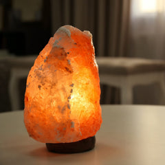 Spantik salt lamp with wood base on bedside table for calm ambience