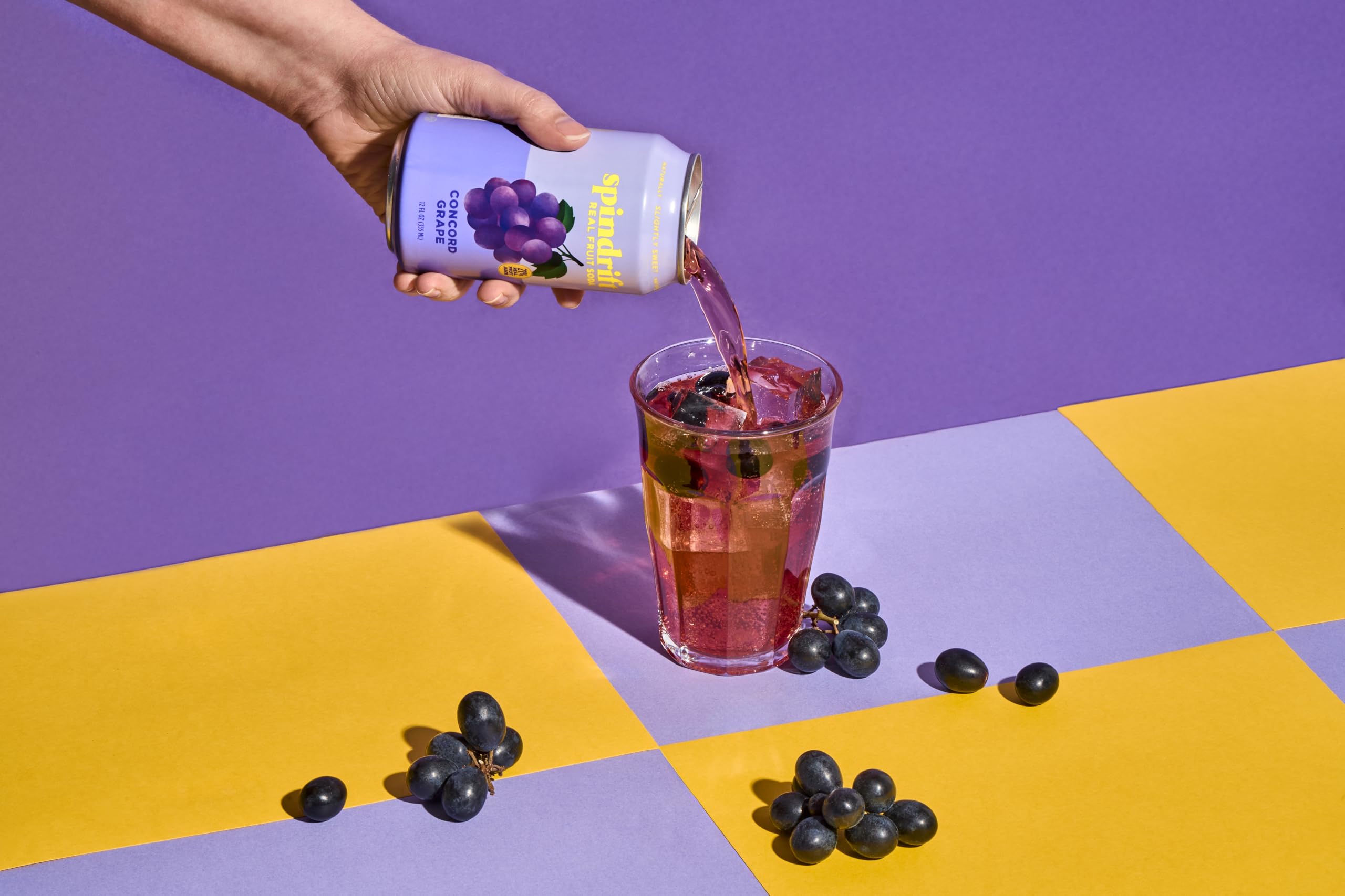 Chilled Concord Freeze can beside a lemon wedge for flavor pairing.