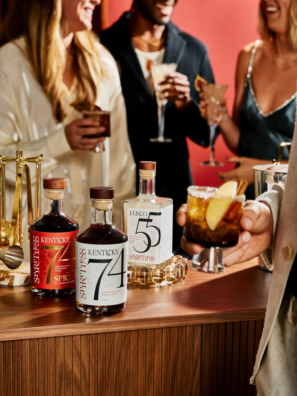 Spiritless Kentucky 74 bottle with glass on bar highlights mindful drinking alternatives.