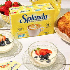 SPLENDA packets near a tea mug ideal for sugar-free flavor in hot drinks.