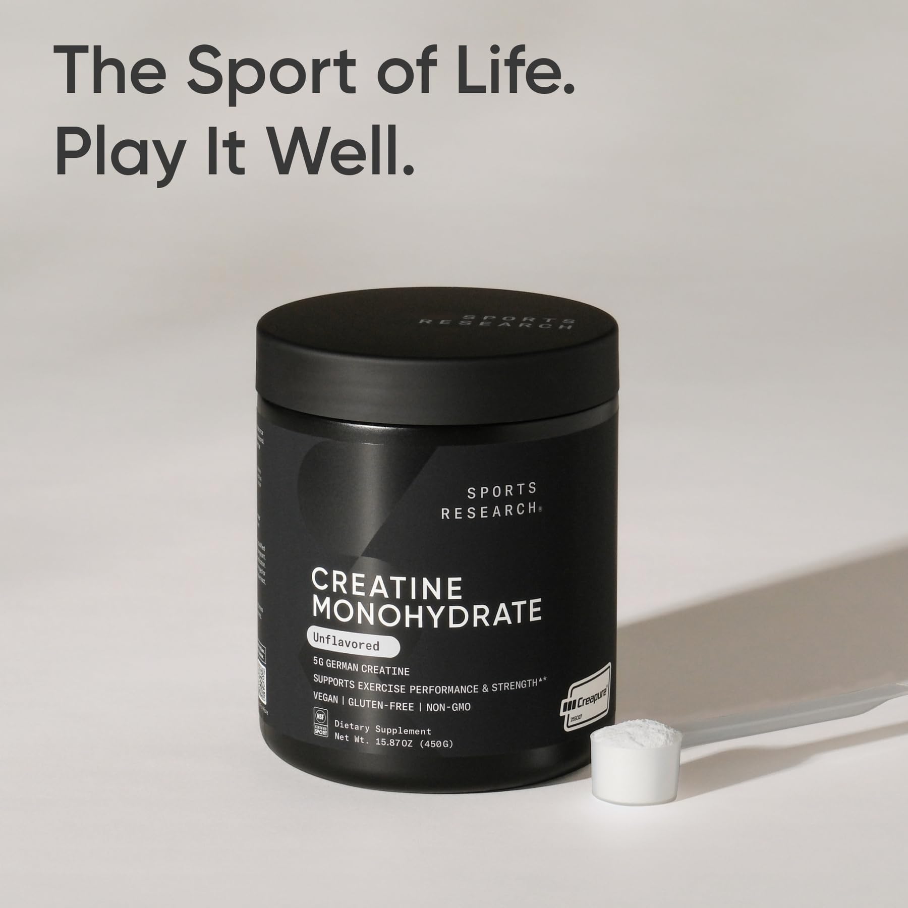 Sports Research creatine monohydrate powder with measuring spoon for dosing.