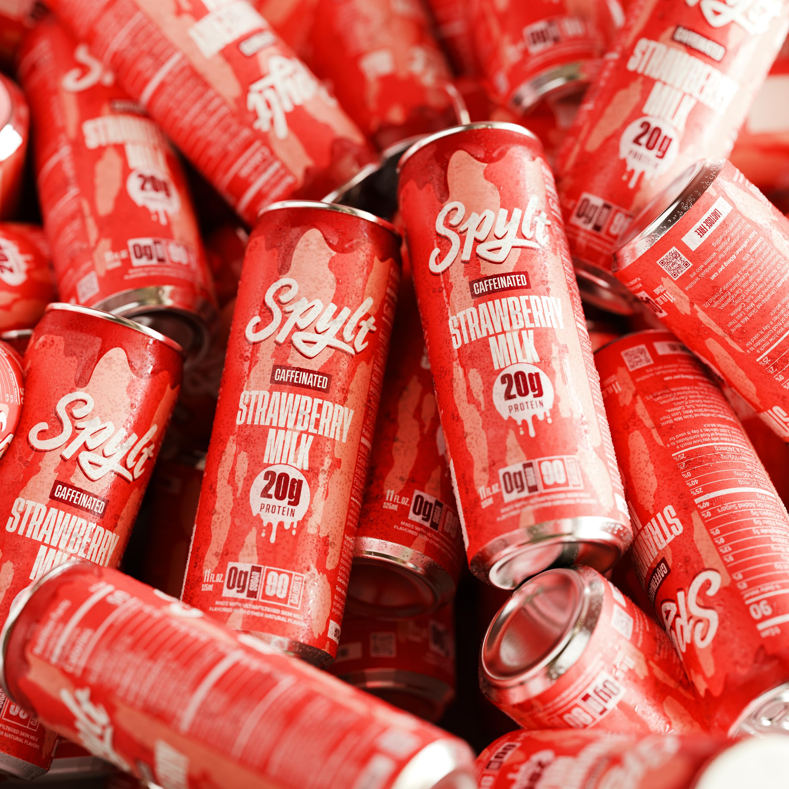 Spylt strawberry milk held in hand during gym break for quick sip.
