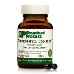 Standard Process Chlorophyll Complex bottle on countertop signaling detox support.