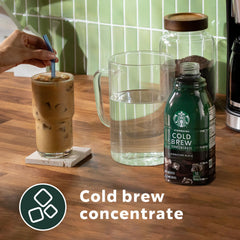 Starbucks Signature Black bottle pouring into a glass for a smooth cold brew.