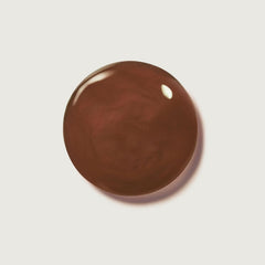 Application close-up of Summer Fridays Hot Cocoa lip balm with sheer color.