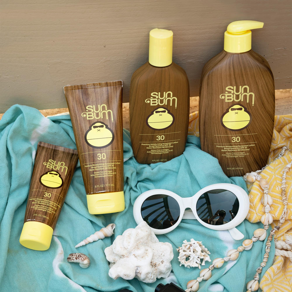 Sun and palm trees with Sun Bum sunscreen on a beach day