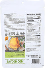 SunFood Superfoods Golden Milk powder scoop close-up, rich turmeric blend ready to mix.