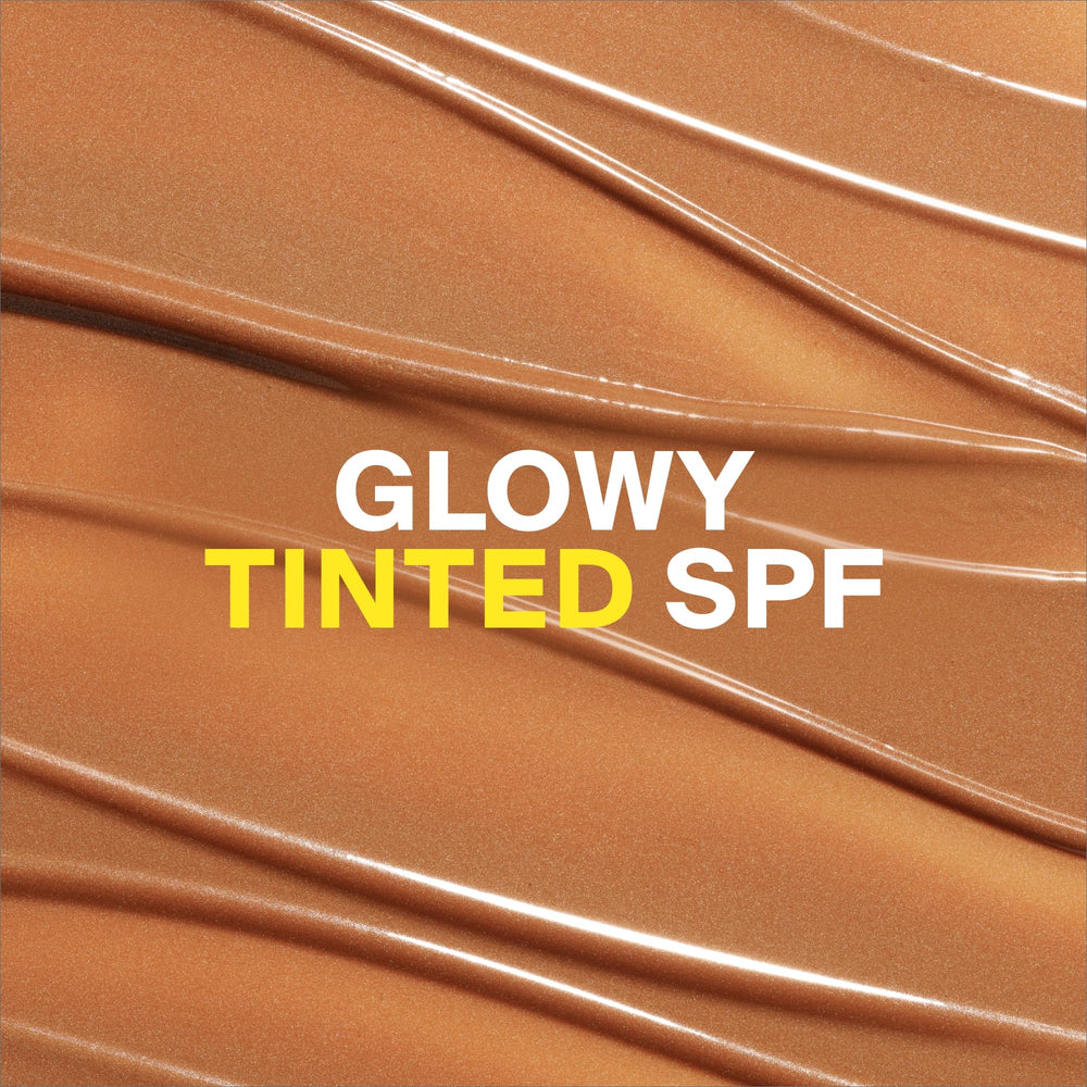 Applying Glowscreen Golden Hour for a dewy bronze finish on the cheek.