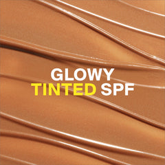 Applying Glowscreen Golden Hour for a dewy bronze finish on the cheek.