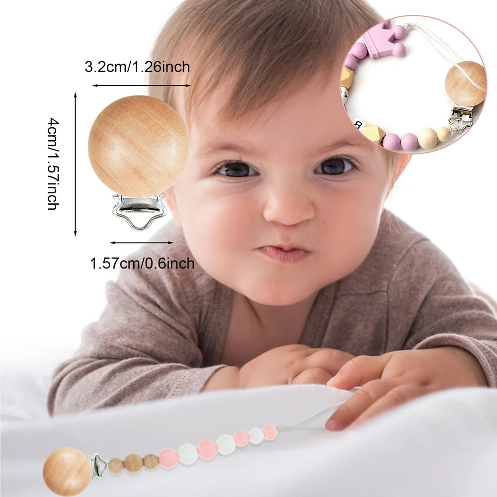 Close-up of Suptizizkz wooden pacifier clip showing smooth finish.