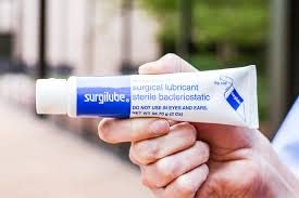Surgilube tube with flip-cap, close-up, sterile lubrication for catheter insertion.