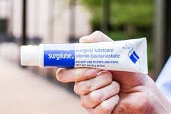 Surgilube tube with flip-cap, close-up, sterile lubrication for catheter insertion.