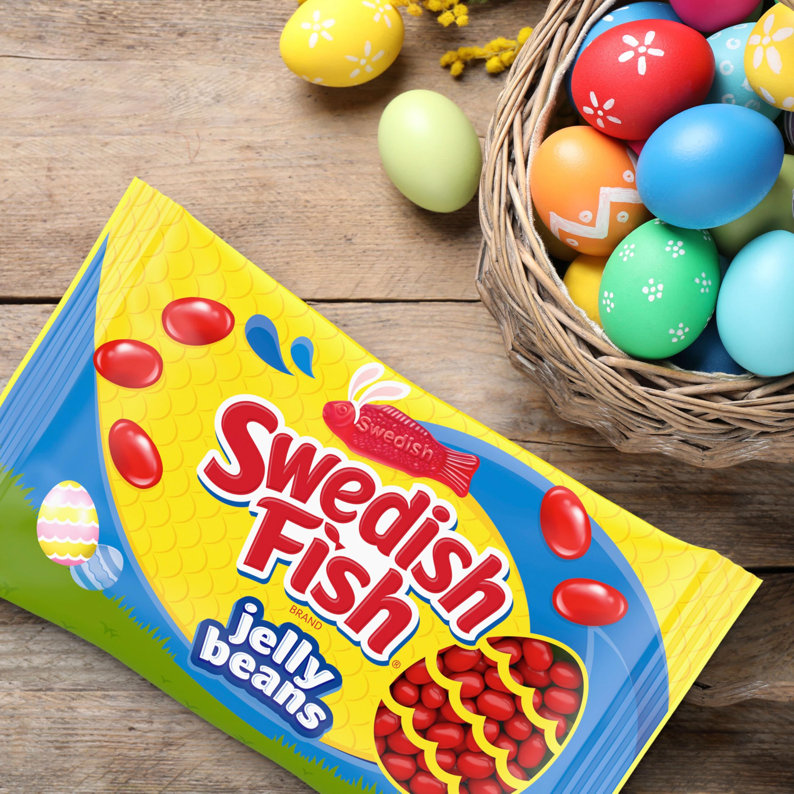 Colorful candy pours from a bag into a party spread.