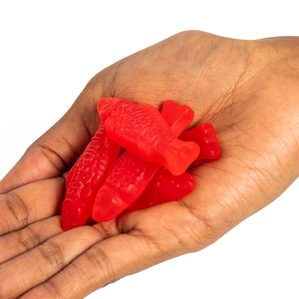 Swedish Fish family snacking image conveys shareable, fat-free candy option.