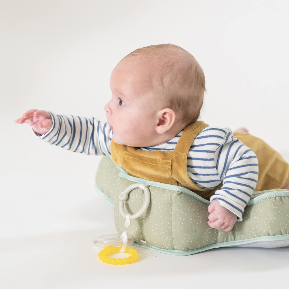 Parent and baby interaction during tummy time with Taf Toys toys