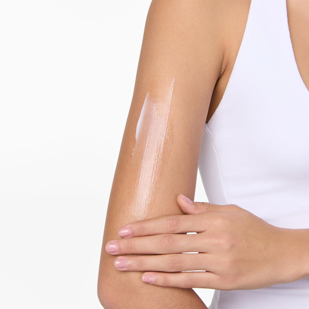 Tanologist Daily Glow on dry areas like elbows for targeted hydration.