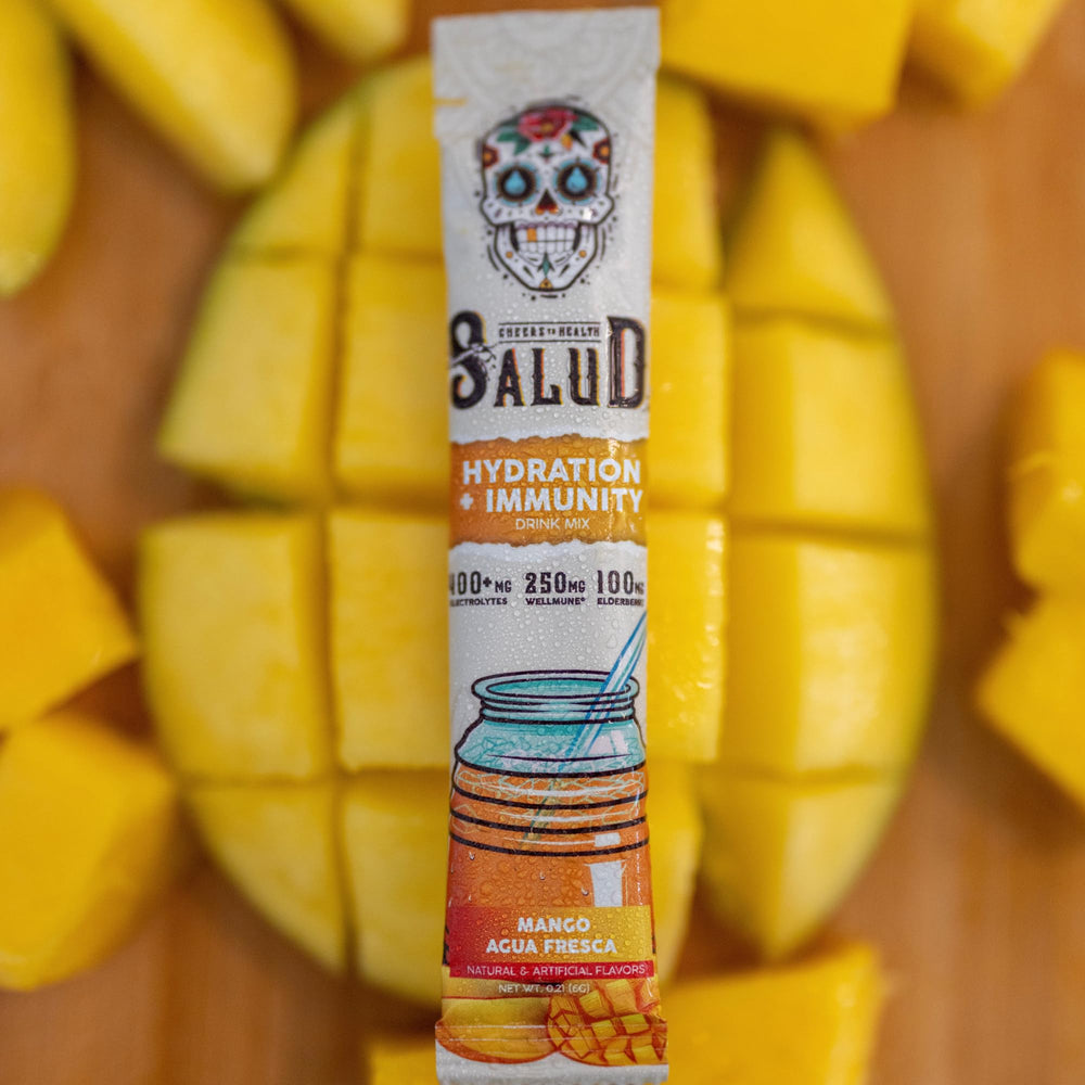 Taste Salud gluten-free non-GMO hydration powder beside fresh fruit.