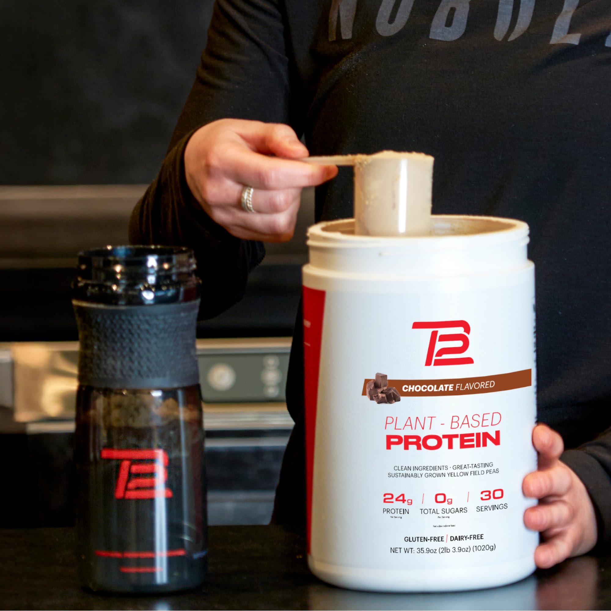 TB12 chocolate protein powder mixing texture close-up shows smooth blend.