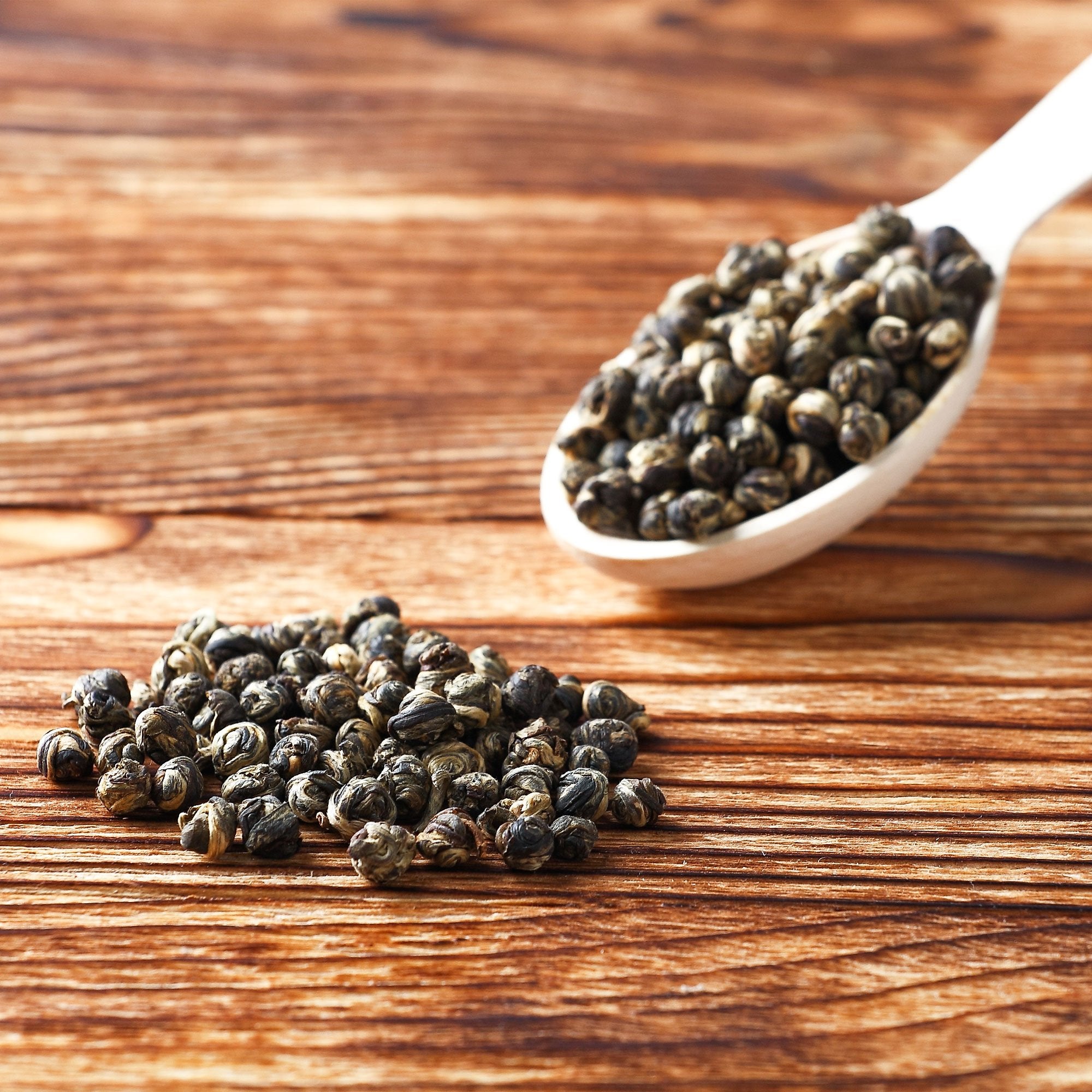 Tealyra Imperial Jasmine Dragon Pearls dry leaves closeup showing premium quality tea leaves