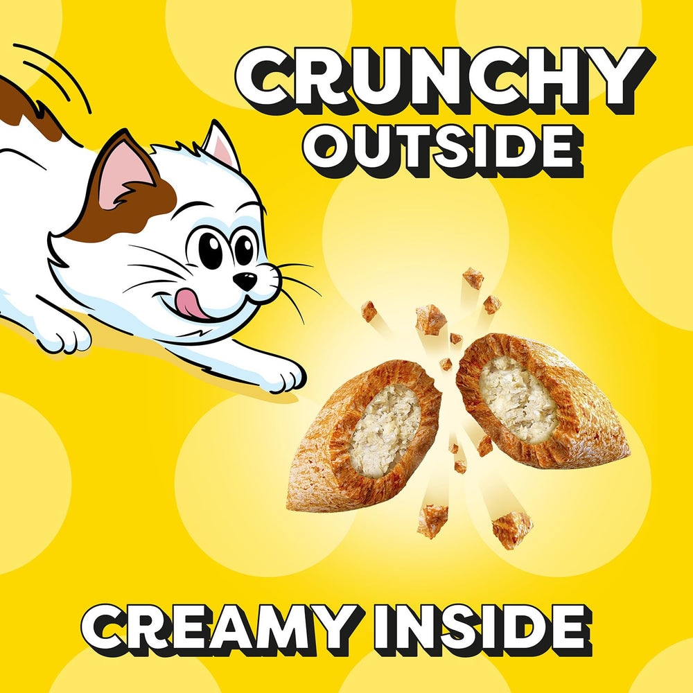 A kitten eagerly enjoys Temptations crunchy outside and soft inside textures.