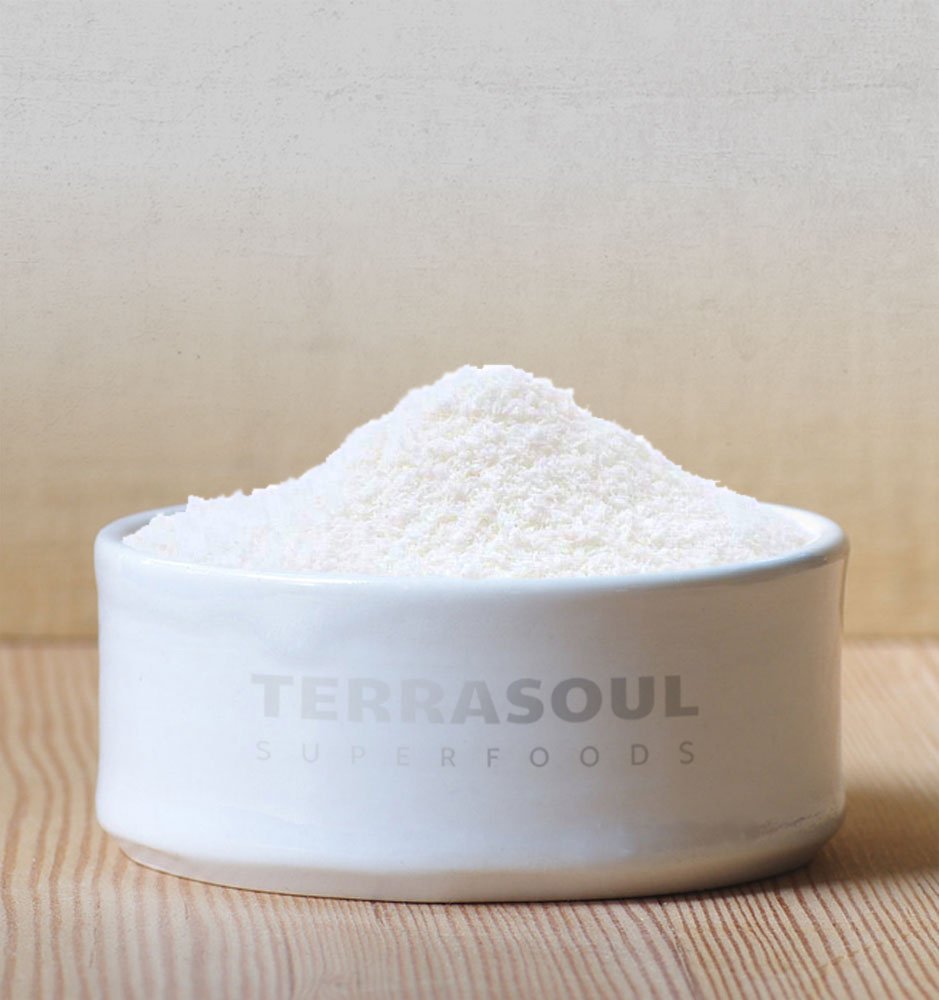 Terrasoul coconut flakes in a bowl over granola showcase versatile topping.