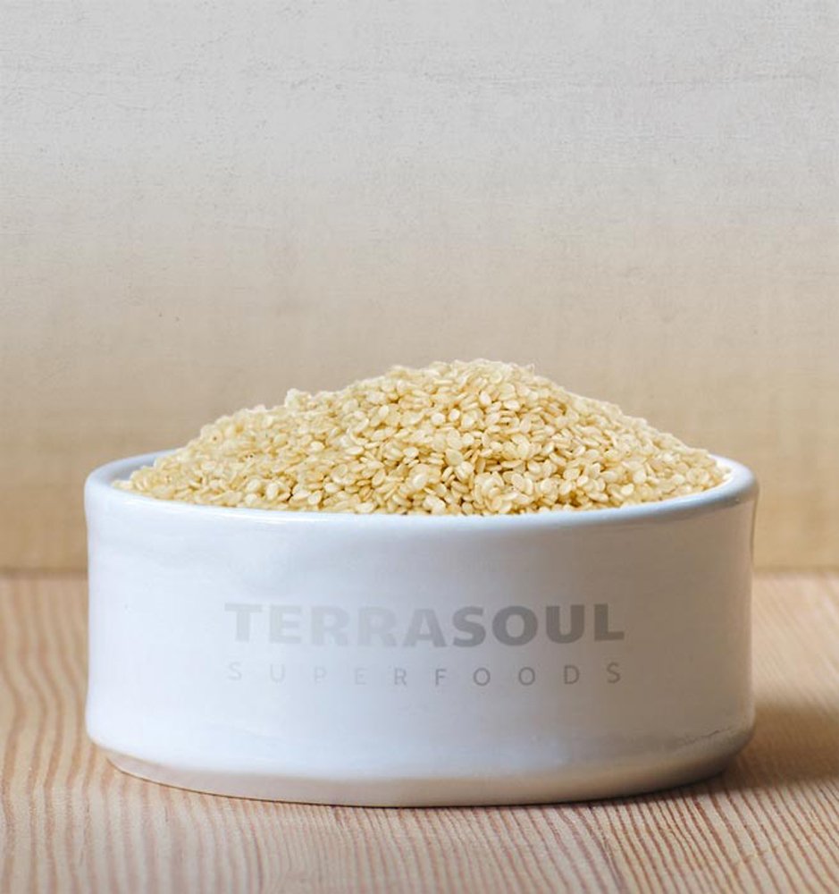 Terrasoul sesame seeds in measuring cup, ideal for precise cooking and baking.