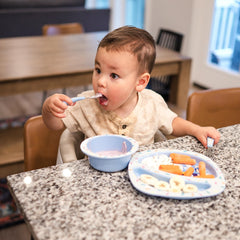The First Years Bluey bowl with deep sides aids scooping for self-feeding.