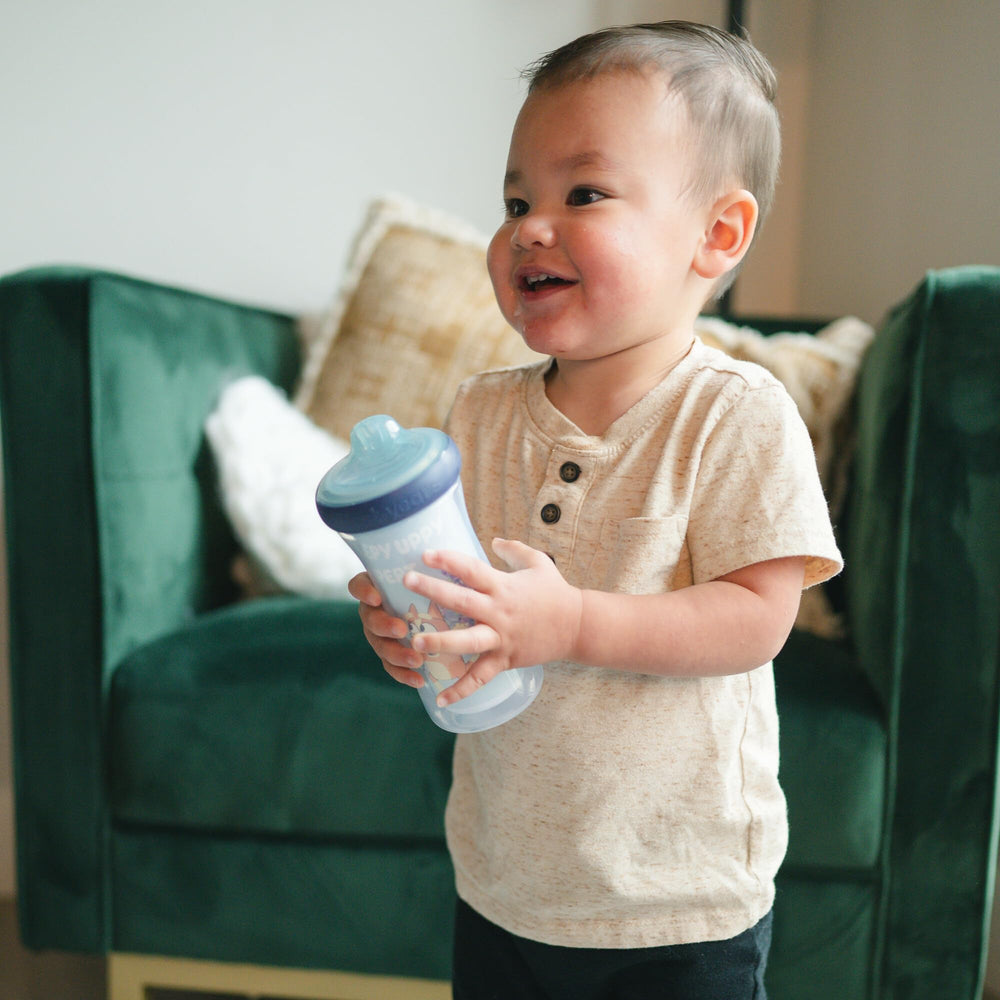 The First Years Bluey sippy cup features a DropGuard bumper to cushion drops.