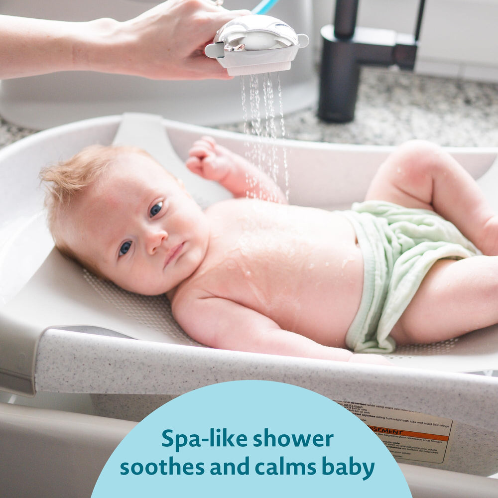 The First Years Rain Shower rotating arm directs a soothing spray for calm baths.