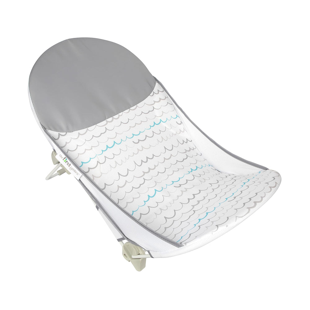 The First Years Sure Comfort folding bather open in sink for quick infant bath.