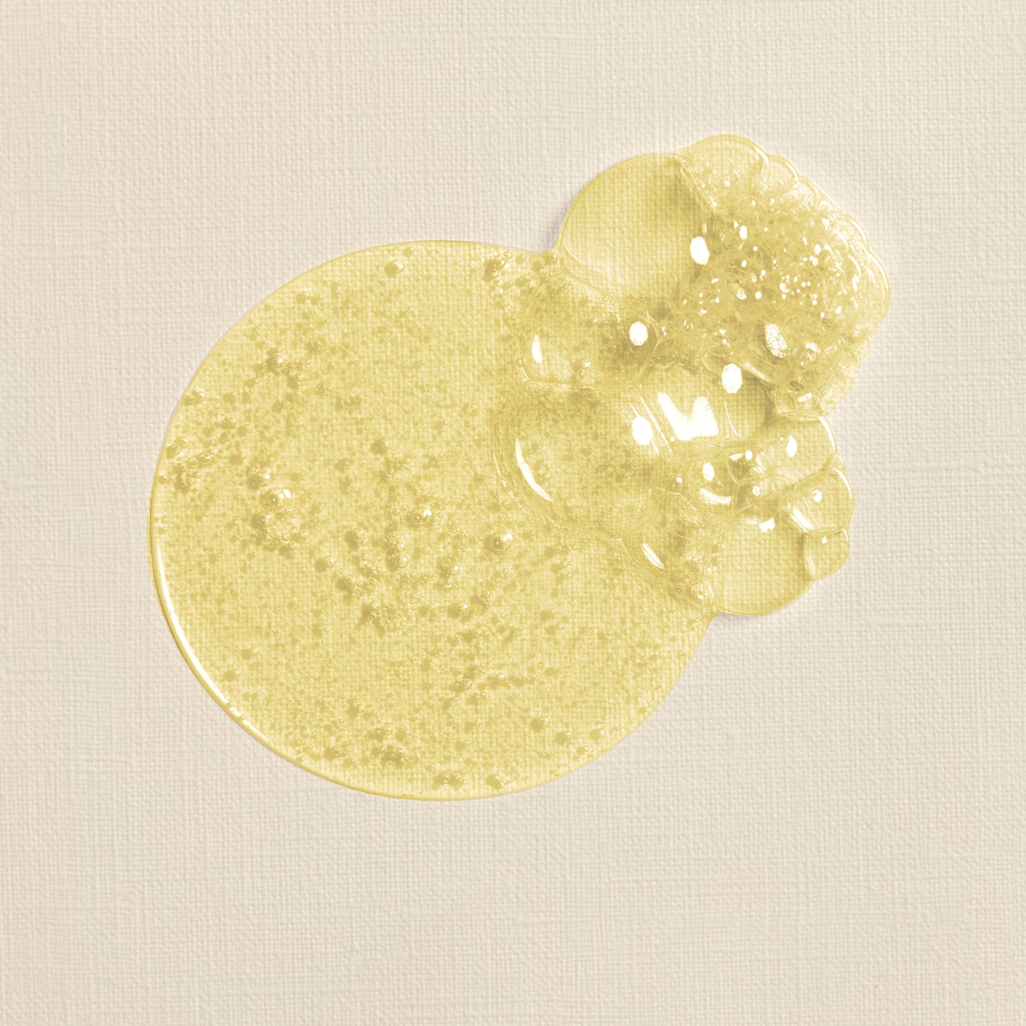 Baby skin close-up with The Honest Company oil showing softened, hydrated skin.