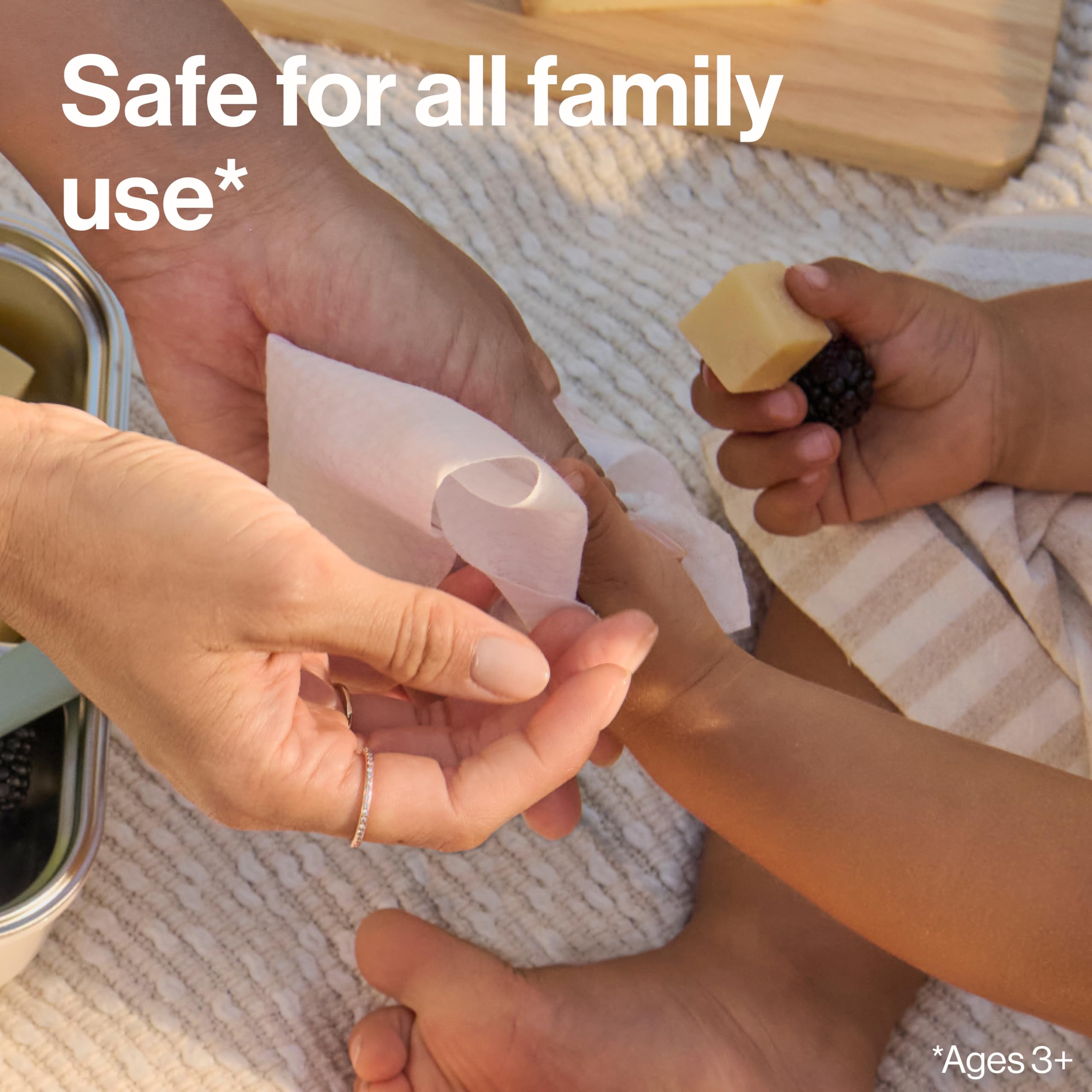 Family-use scene showing multiple hands with dermatologist-tested formula.