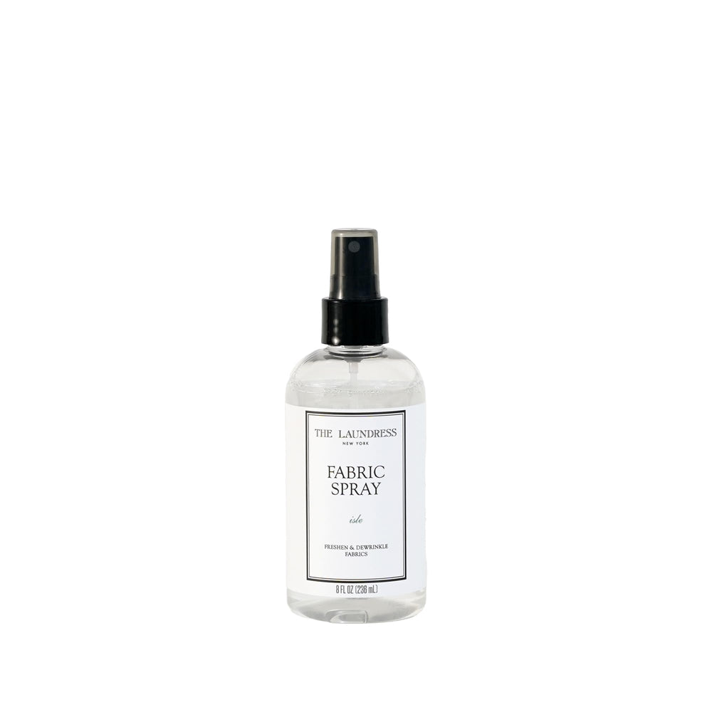 The Laundress Isle fabric spray bottle refreshing fabrics with a coastal scent.