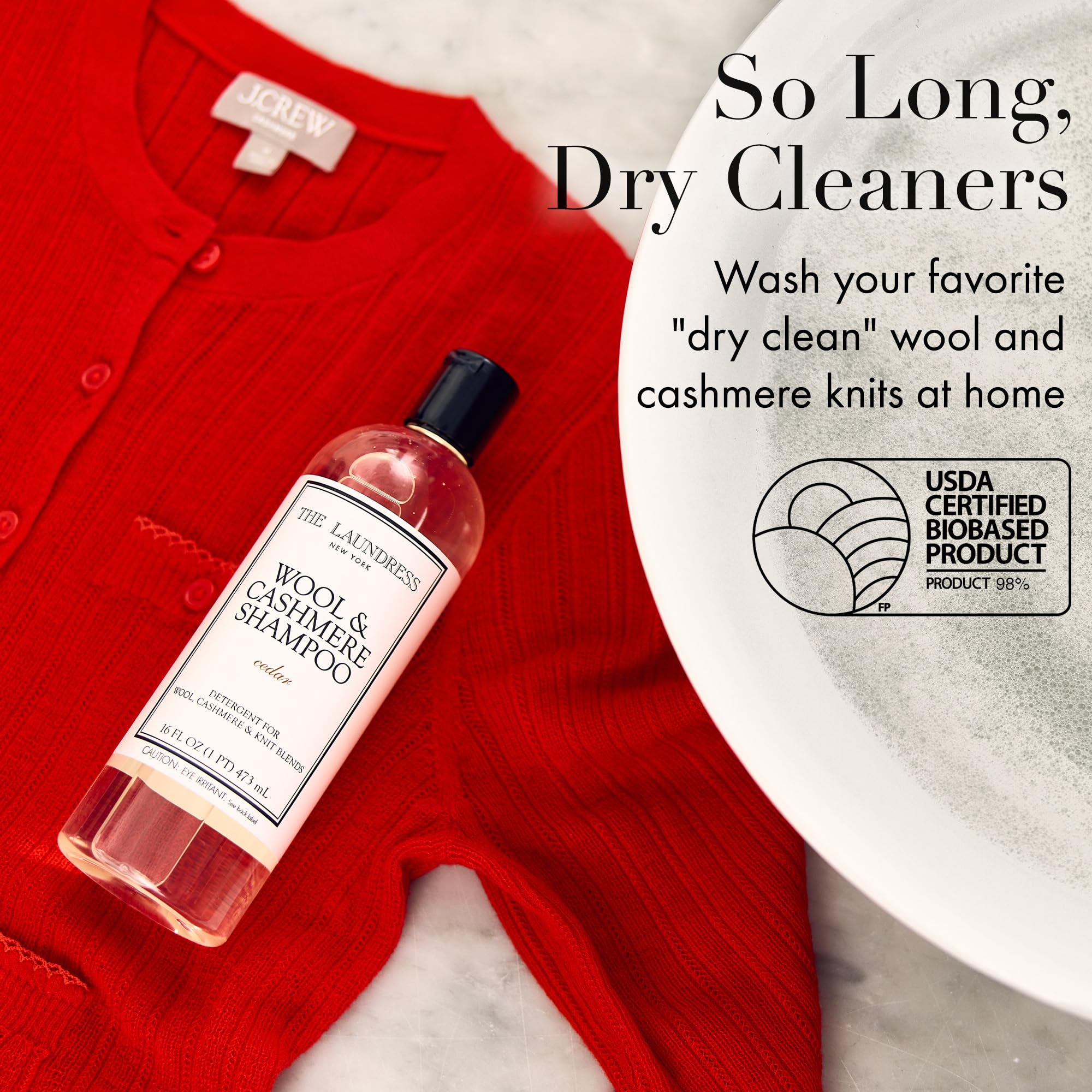The Laundress Wool & Cashmere Shampoo label close-up highlights cedar scent and enzyme-free care.