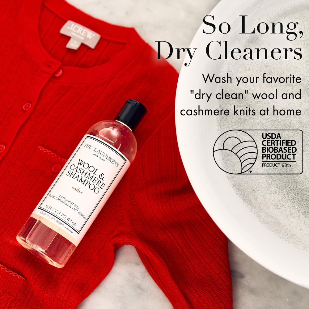 The Laundress Wool & Cashmere Shampoo label close-up highlights cedar scent and enzyme-free care.