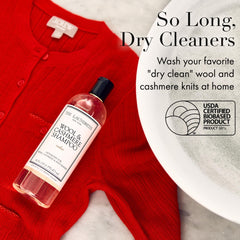 The Laundress Wool & Cashmere Shampoo label close-up highlights cedar scent and enzyme-free care.