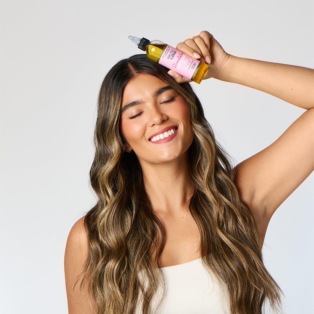 The Mane Attraction hair oil being applied for lightweight, non-greasy moisture.