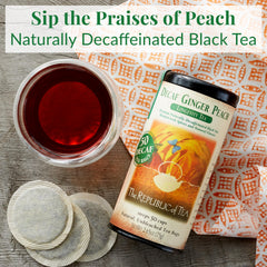The Republic of Tea decaf ginger peach tea bag steeping in hot water, savor the aroma.