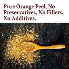 The Spice Way orange peel granules on a spoon release citrus aroma for tea and meat dishes.