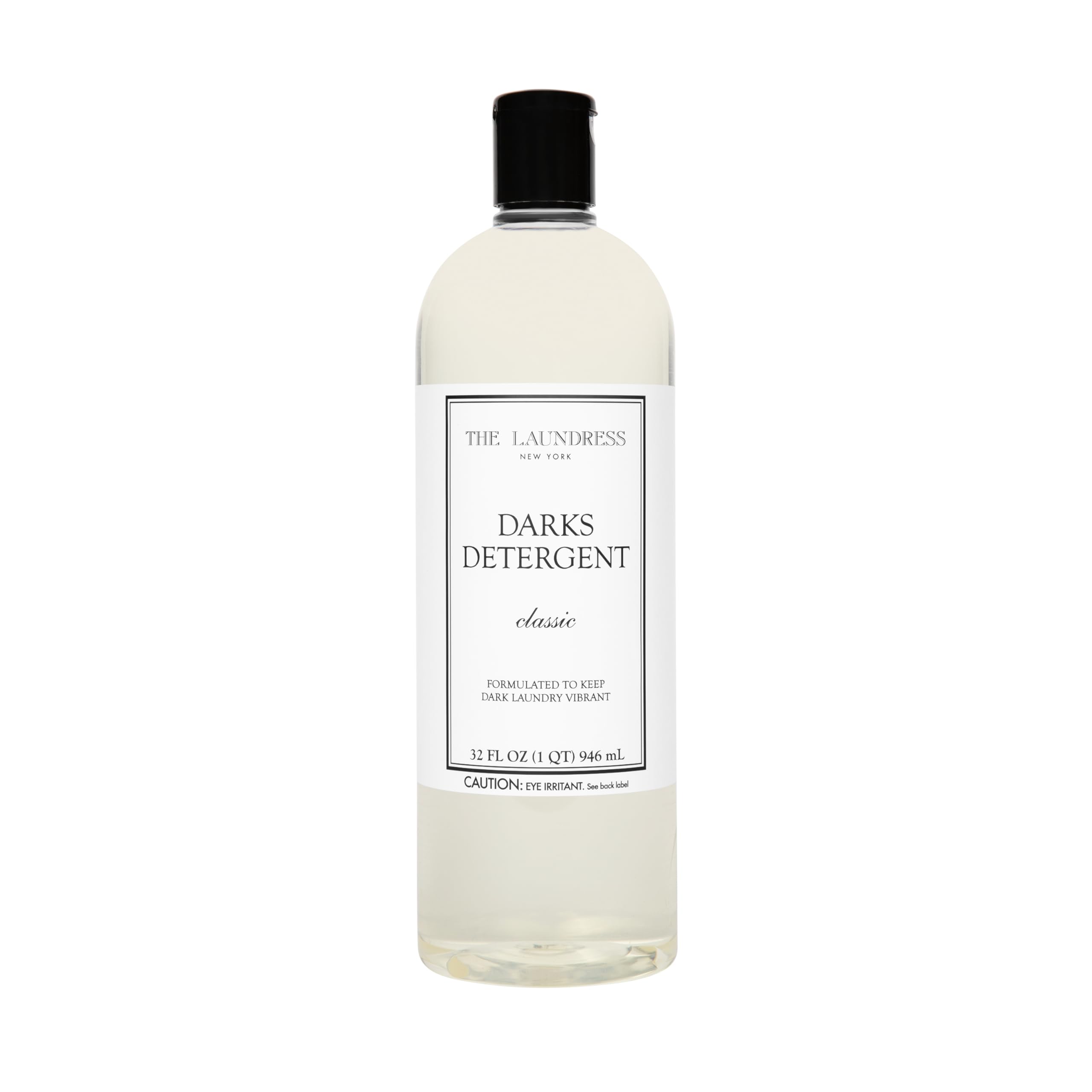 The Laundress Darks Detergent bottle pour showing stain-fighting care for vibrant darks