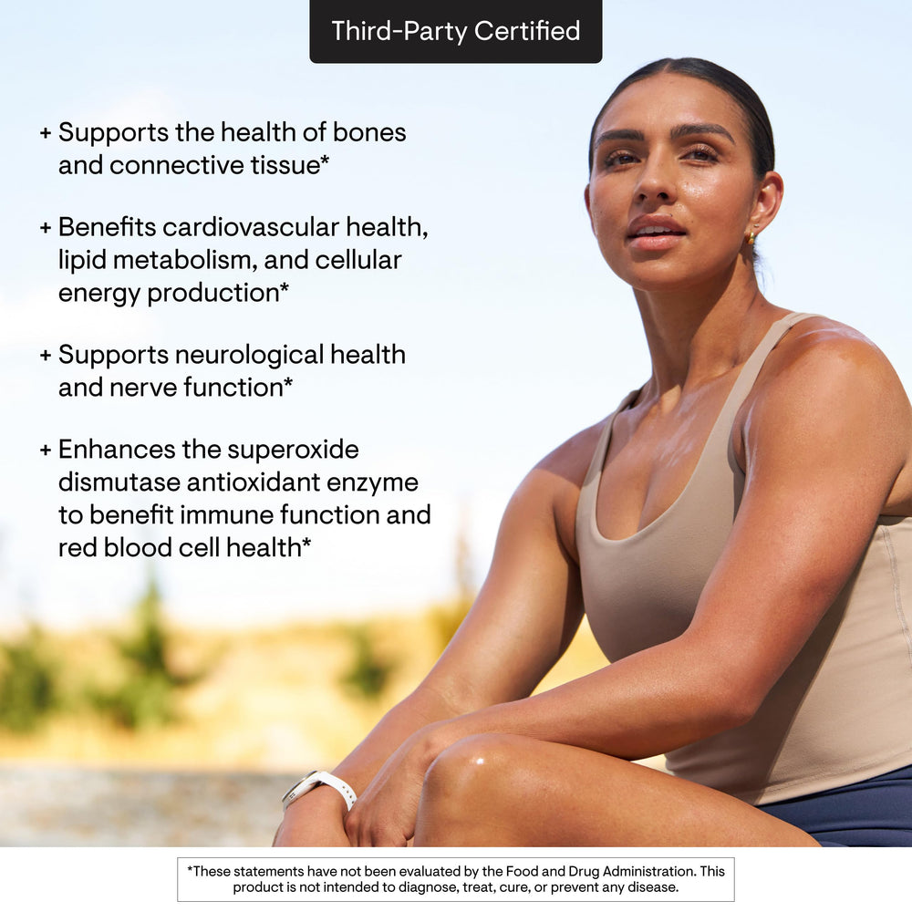 THORNE Copper Bisglycinate capsules on wood background for natural supplementation.