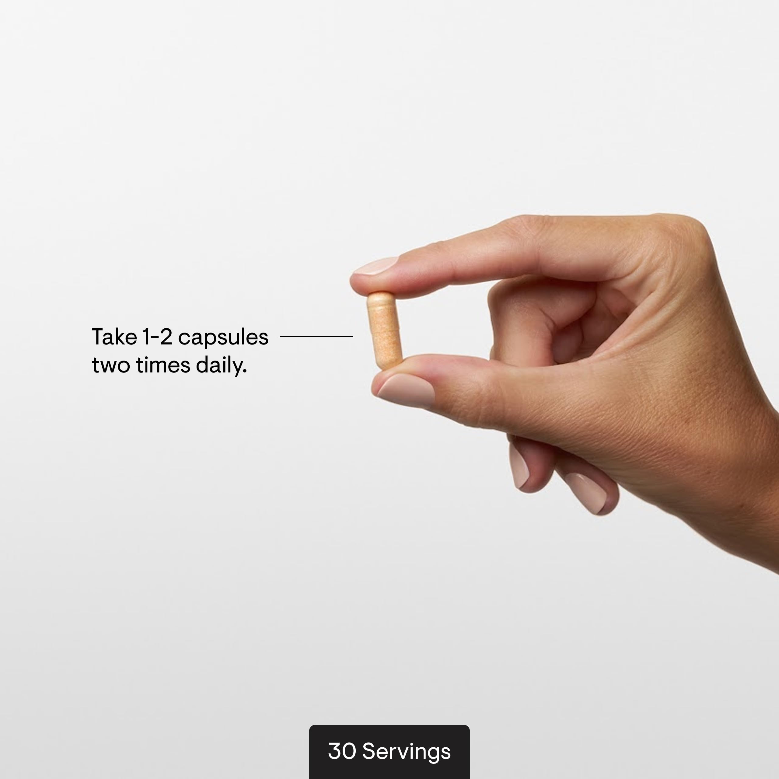 Hand holding THORNE Curcumin Meriva capsule for convenient daily use.